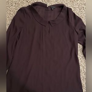 Ann Taylor maroon long sleeved shirt in size medium. Buttons down in back. NWOT